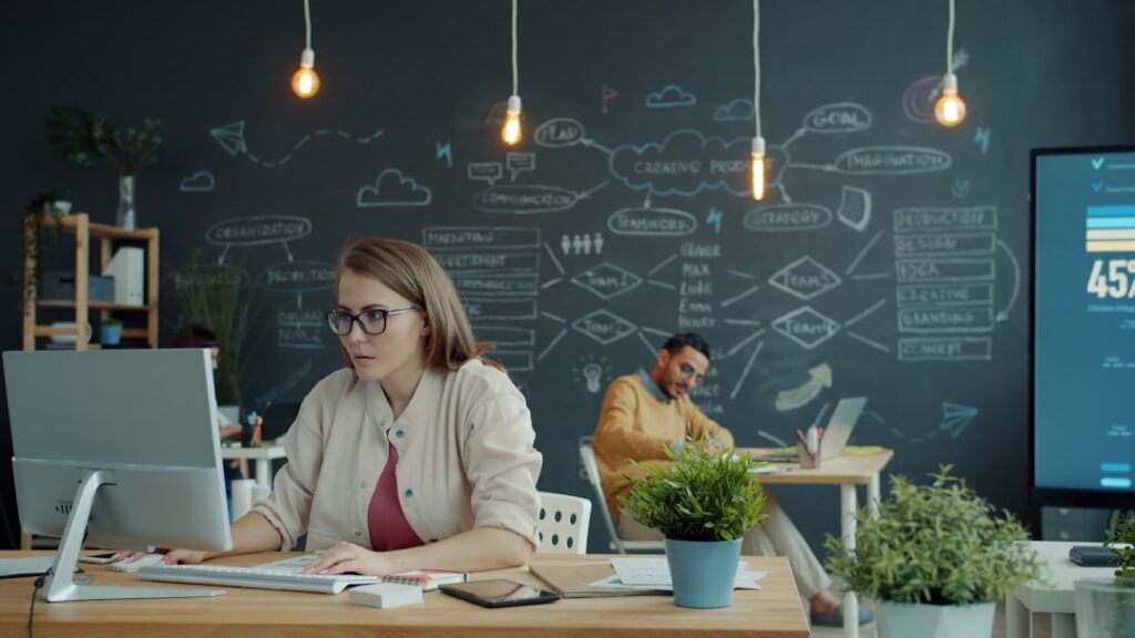 Sleek futuristic advertising agency workspace with holographic AI chatbot interface floating above glass desk, neon blue ambient lighting, professional creative team observing data visualization