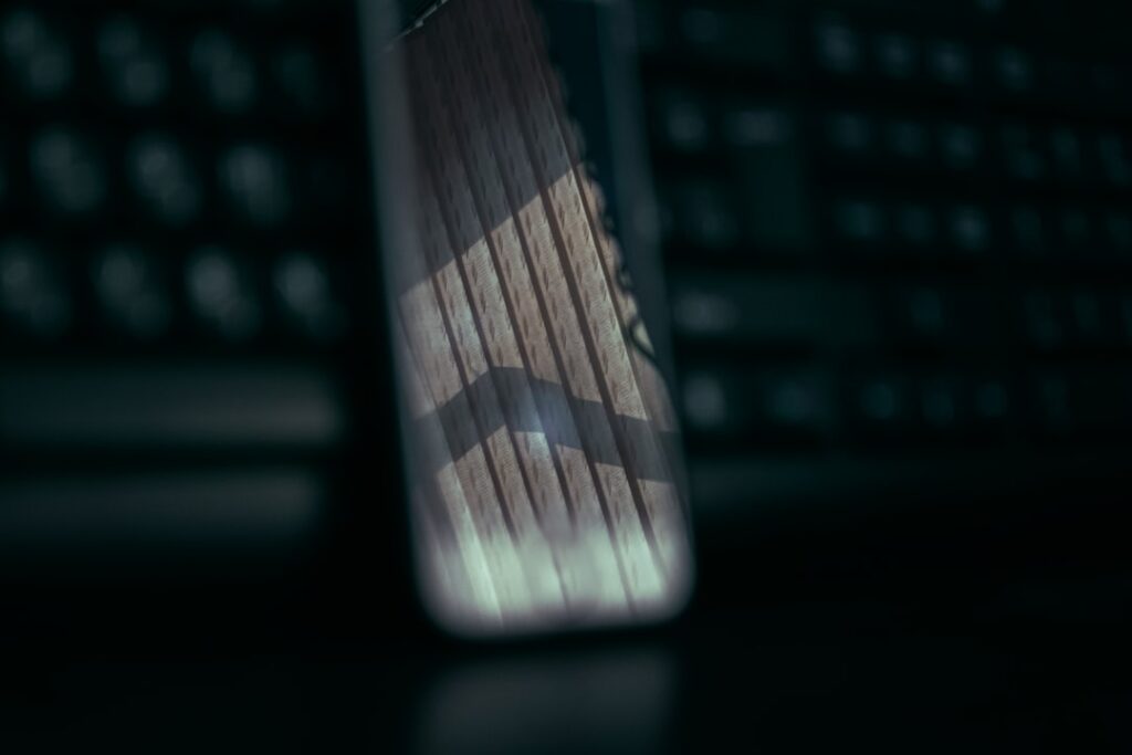 Close-up of a person's hands holding a sleek smartphone with holographic AI interface glowing above it, clean modern office background, cool blue ambient lighting, futuristic on-device computing conce