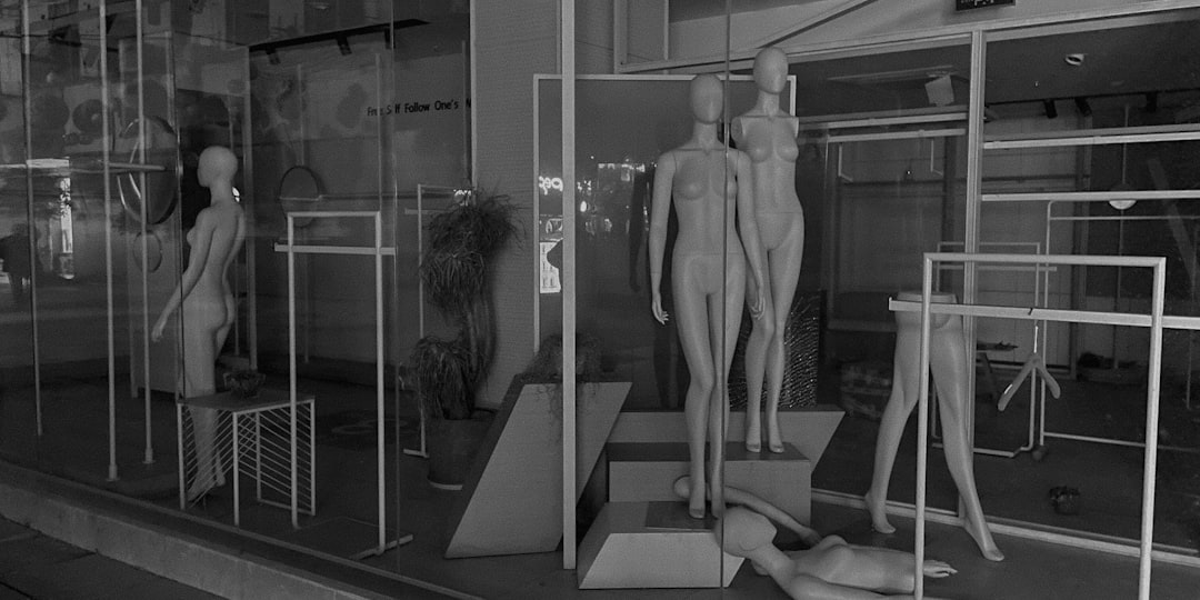 Futuristic fashion fitting room with holographic body scan, sleek ambient lighting, diverse model silhouette with measurement lines, clean modern tech environment, professional editorial style