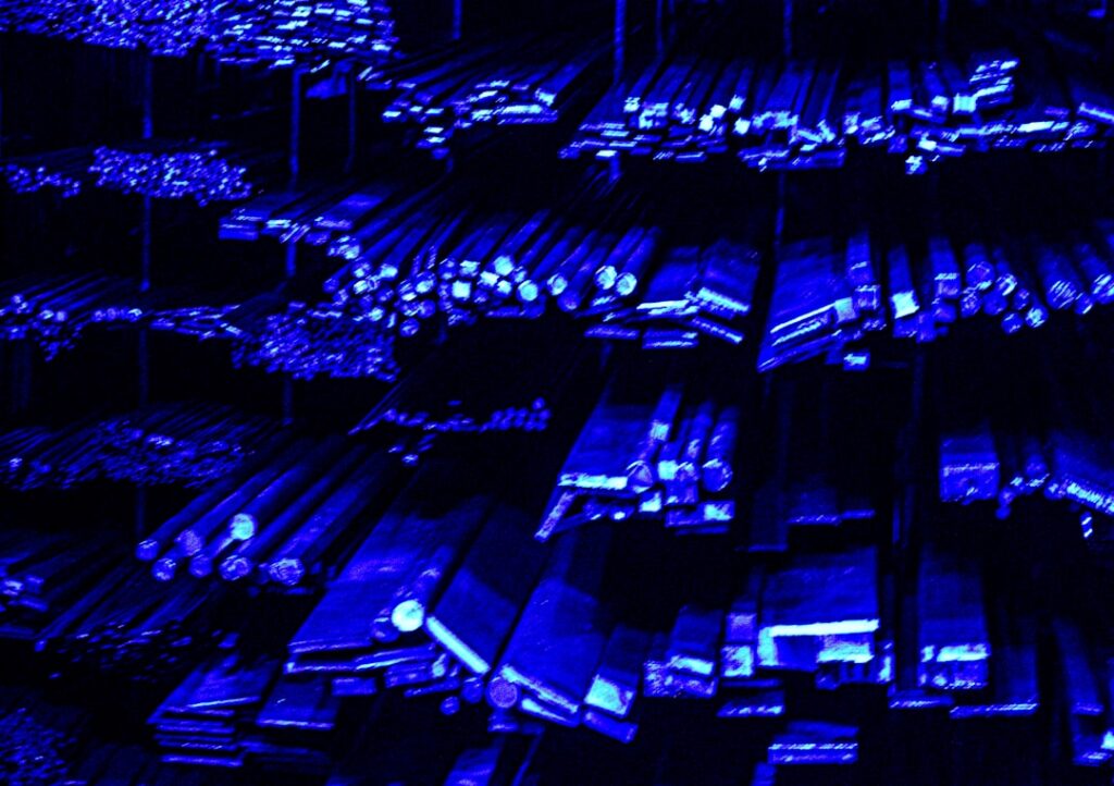 Futuristic data center with ambient blue lighting, server racks forming neural network patterns, professional engineer monitoring holographic AI infrastructure dashboard, sleek corporate environment
