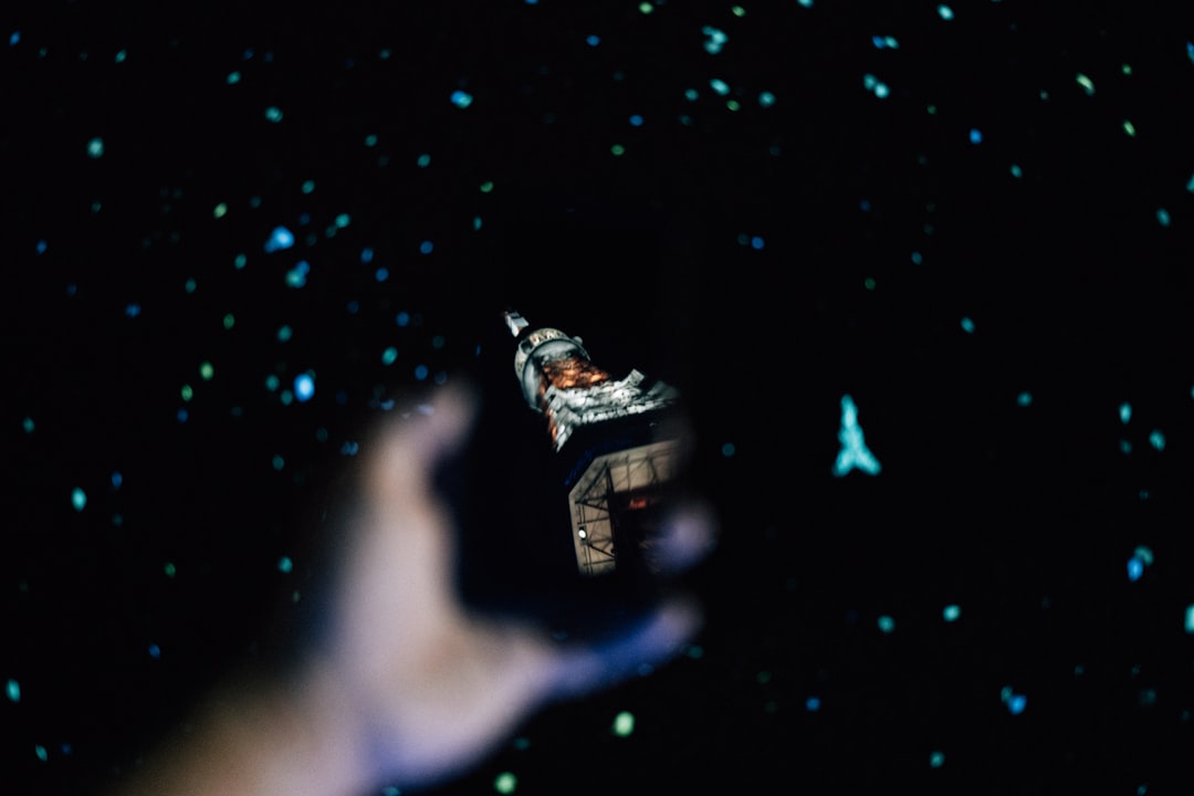 Humanoid robot hand reaching toward human hand against backdrop of Earth from space, holographic AI neural networks connecting continents, sleek futuristic lighting, professional technology collaborat