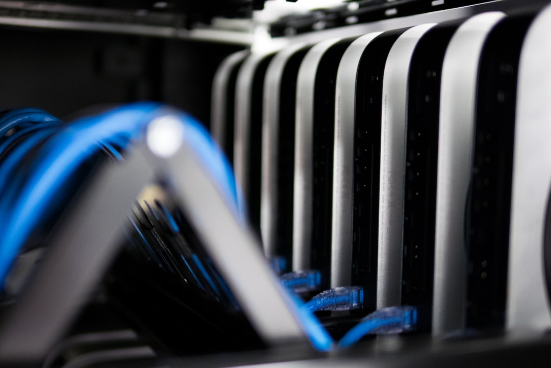 A sleek futuristic data center with ambient blue lighting, neural network visualization holograms floating above server racks, professional engineer in clean modern office attire examining a transpare