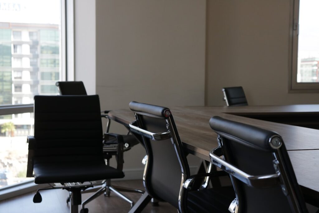 Futuristic sleek law office with holographic legal documents floating above desk, lawyer silhouette examining neural network visualization, cool blue ambient lighting, clean modern professional settin