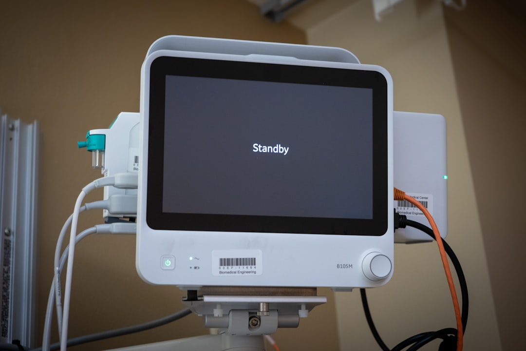 Elegant autonomous medical robot assistant monitoring patient vitals on transparent dashboard, warm ambient lighting, clean modern clinic, human-robot collaboration, futuristic chronic care management