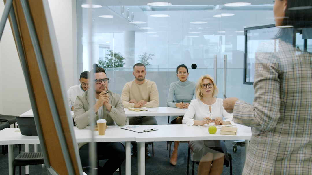 Diverse team of professionals gathered around holographic AI ethics interface in clean modern boardroom, soft ambient lighting, cybersecurity dashboard visible, balanced composition showing human over