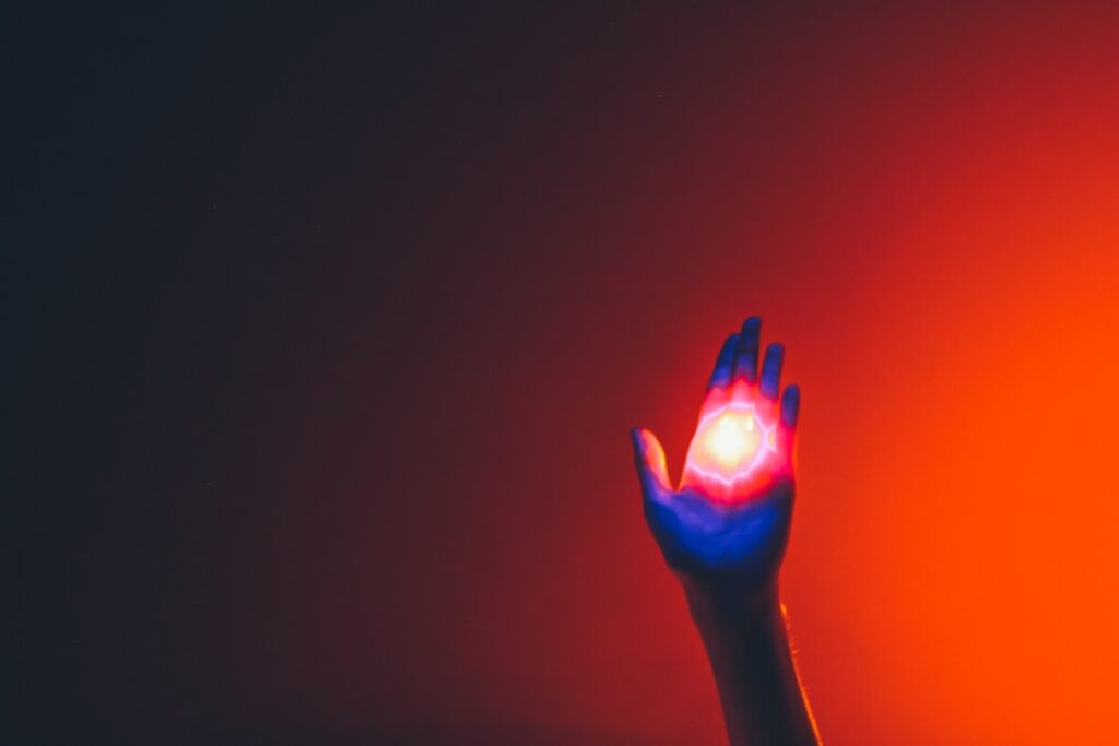 Futuristic human hand halting glowing autonomous AI robot mid-stride in sleek data center, cool blue ambient lighting, tension between control and automation concept, cinematic depth of field, editori