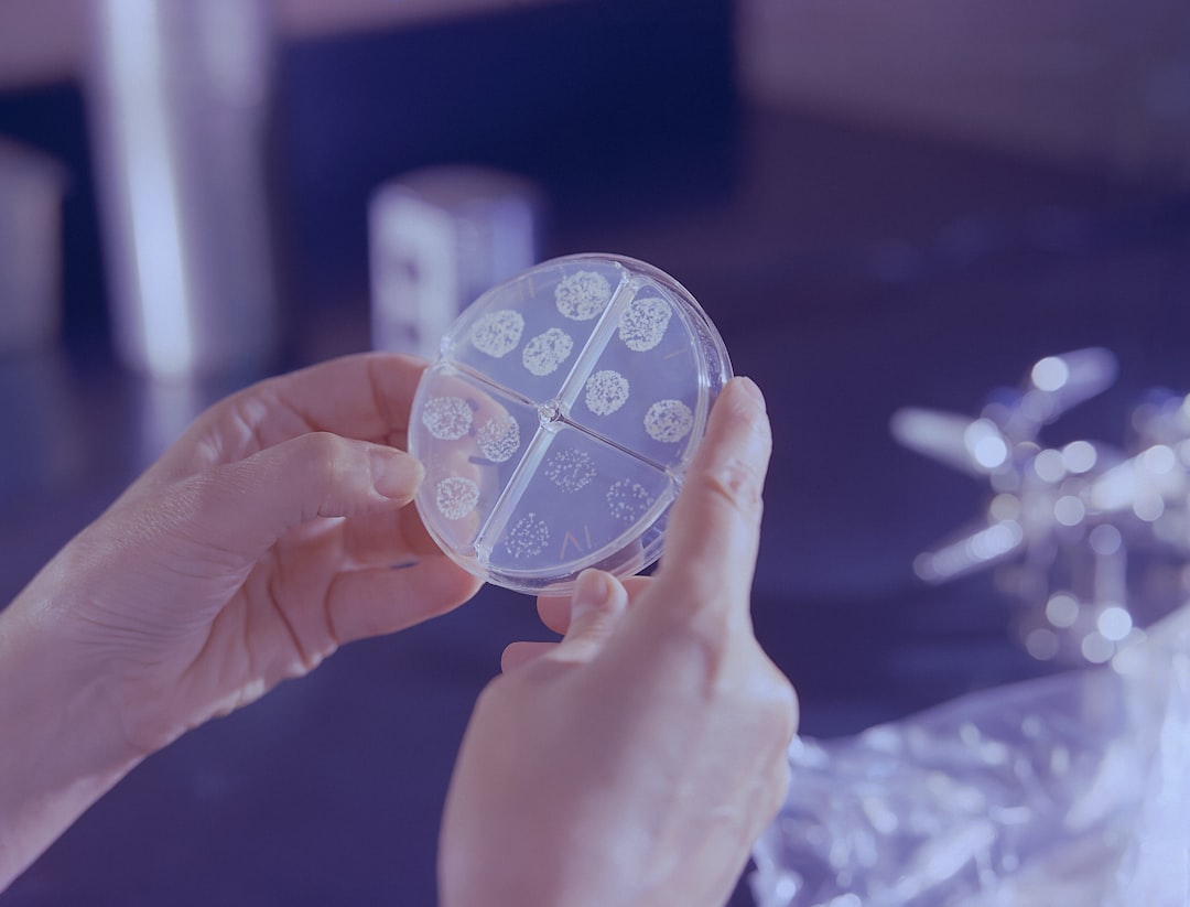 futuristic medical lab with holographic bacteria visualization, scientist in white coat examining glowing petri dish, cool blue ambient lighting, sleek modern equipment, antimicrobial crisis concept