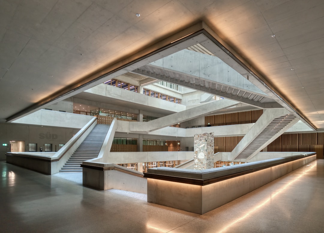 Futuristic Brazilian courthouse interior with holographic legal documents floating above sleek wooden bench, ambient blue lighting, professional lawyer examining neural network visualization on transp