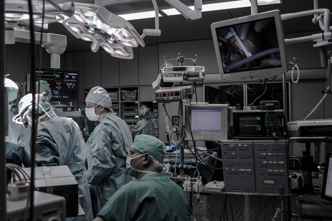 Medical AI robotics in modern hospital setting, professional team observing holographic data display, sleek ambient lighting, real-world technology adoption scene