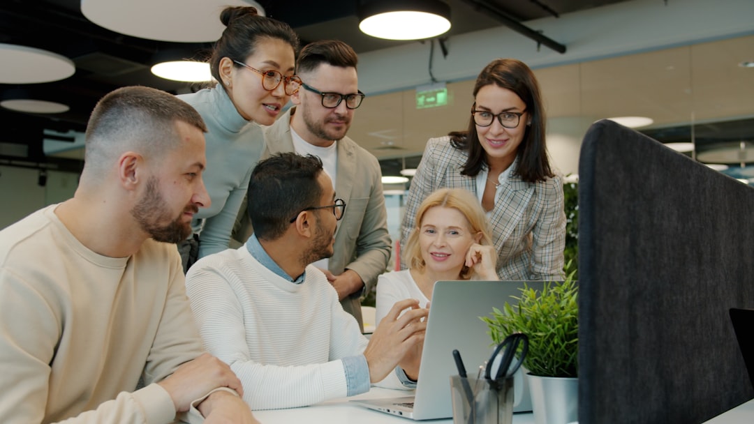 Diverse professional team gathered around sleek transparent screen displaying personalized customer data streams, warm ambient glow, modern tech startup environment, human connection emphasis