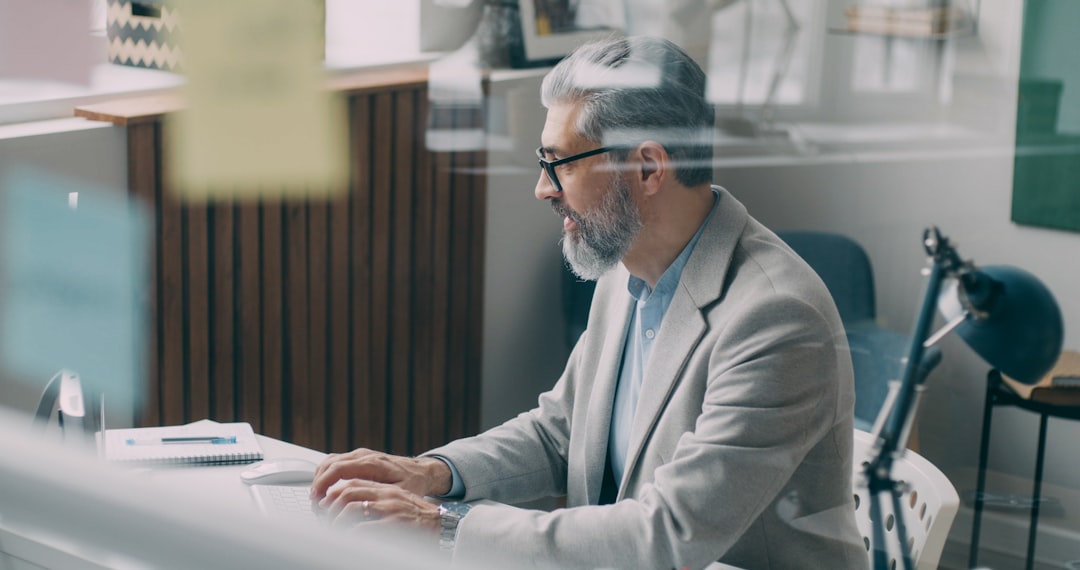 Executive analyzing holographic data streams with neural network visualization floating above sleek glass desk, clean modern office, warm amber and cool cyan lighting, strategic decision-making moment